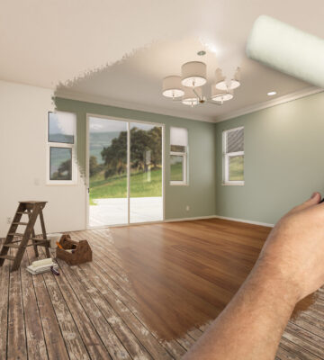 Before and After of Man Painting Roller to Reveal Newly Remodeled Room with Fresh Light Green Paint and New Floors.